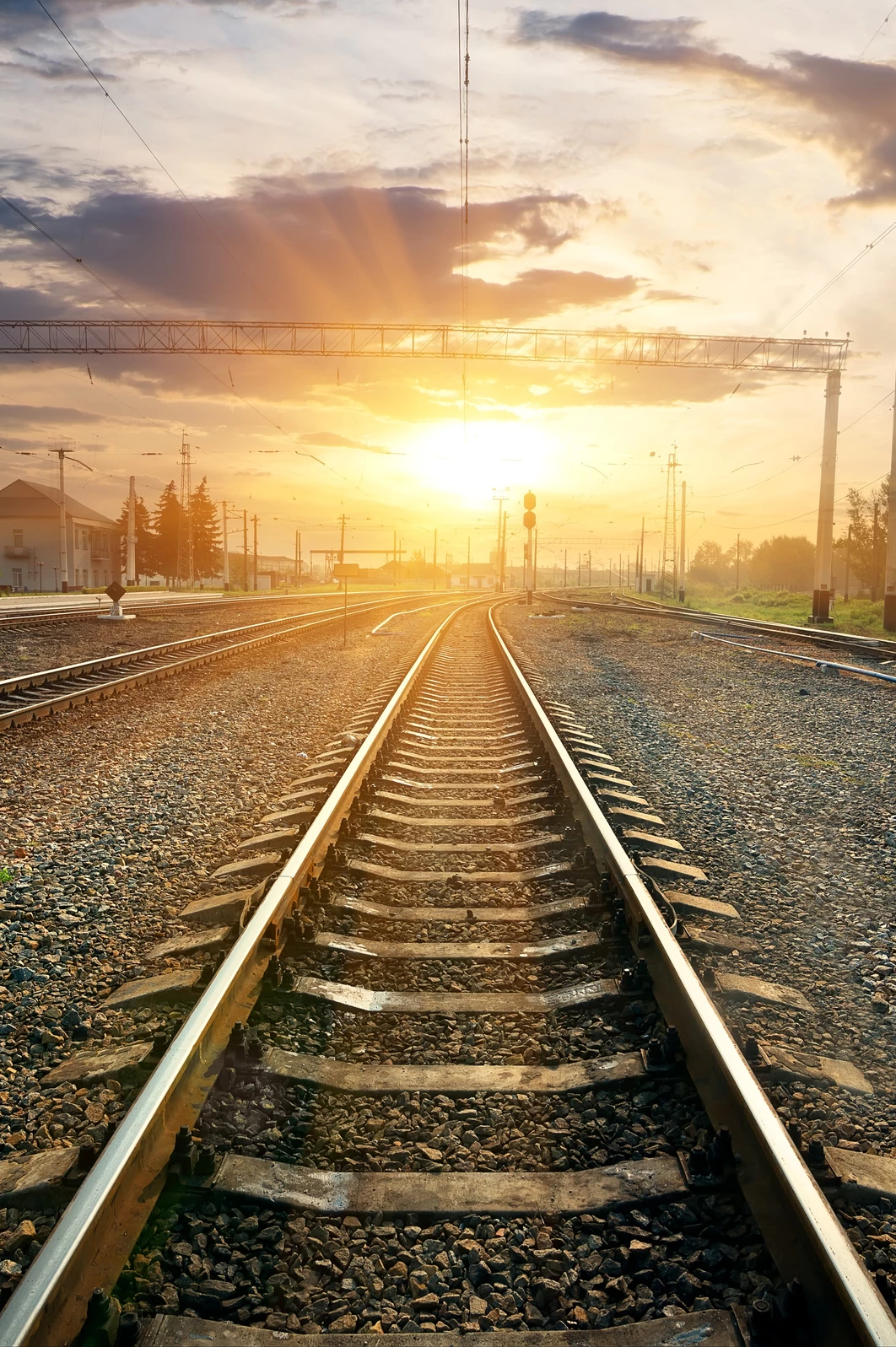 You can see railways in an industrial setting during sunset