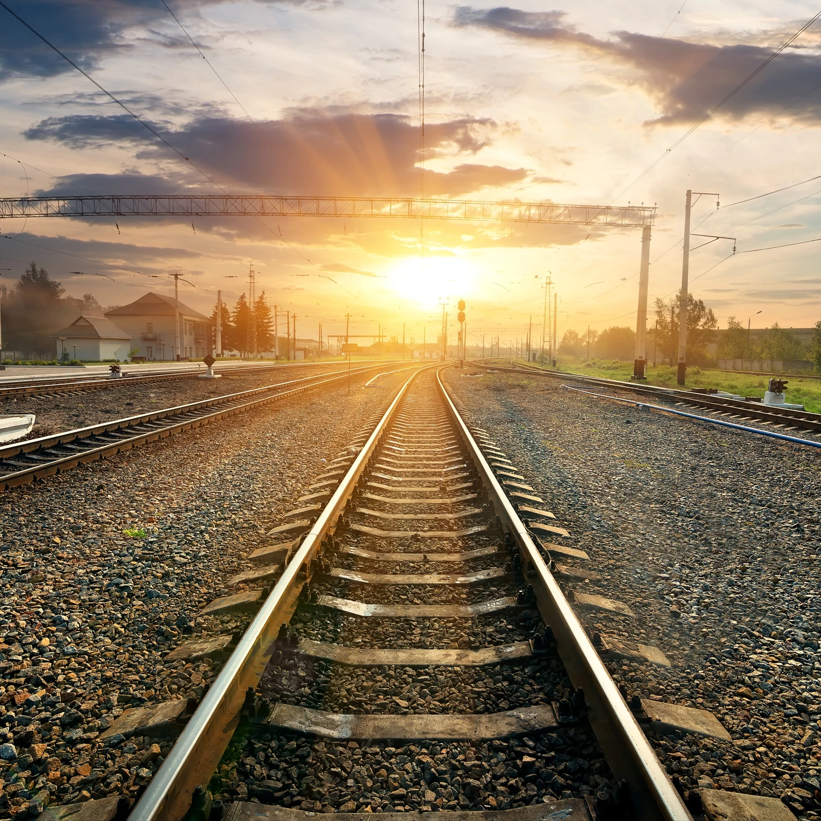 You can see railways in an industrial setting during sunset