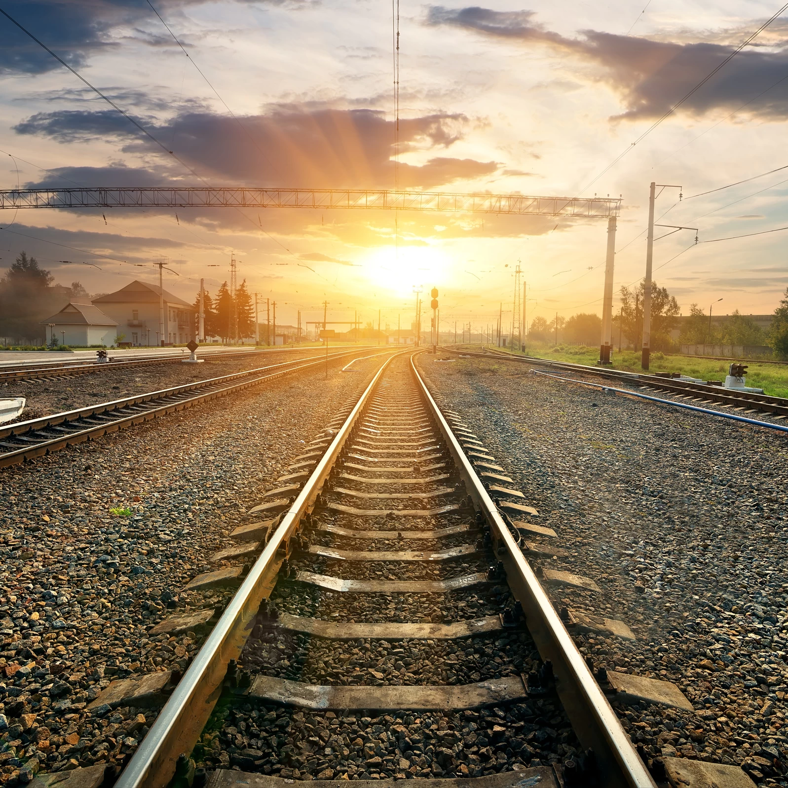 You can see railways in an industrial setting during sunset