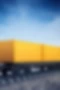 [Translate to Spanish:] A yellow railroad cargo on the way